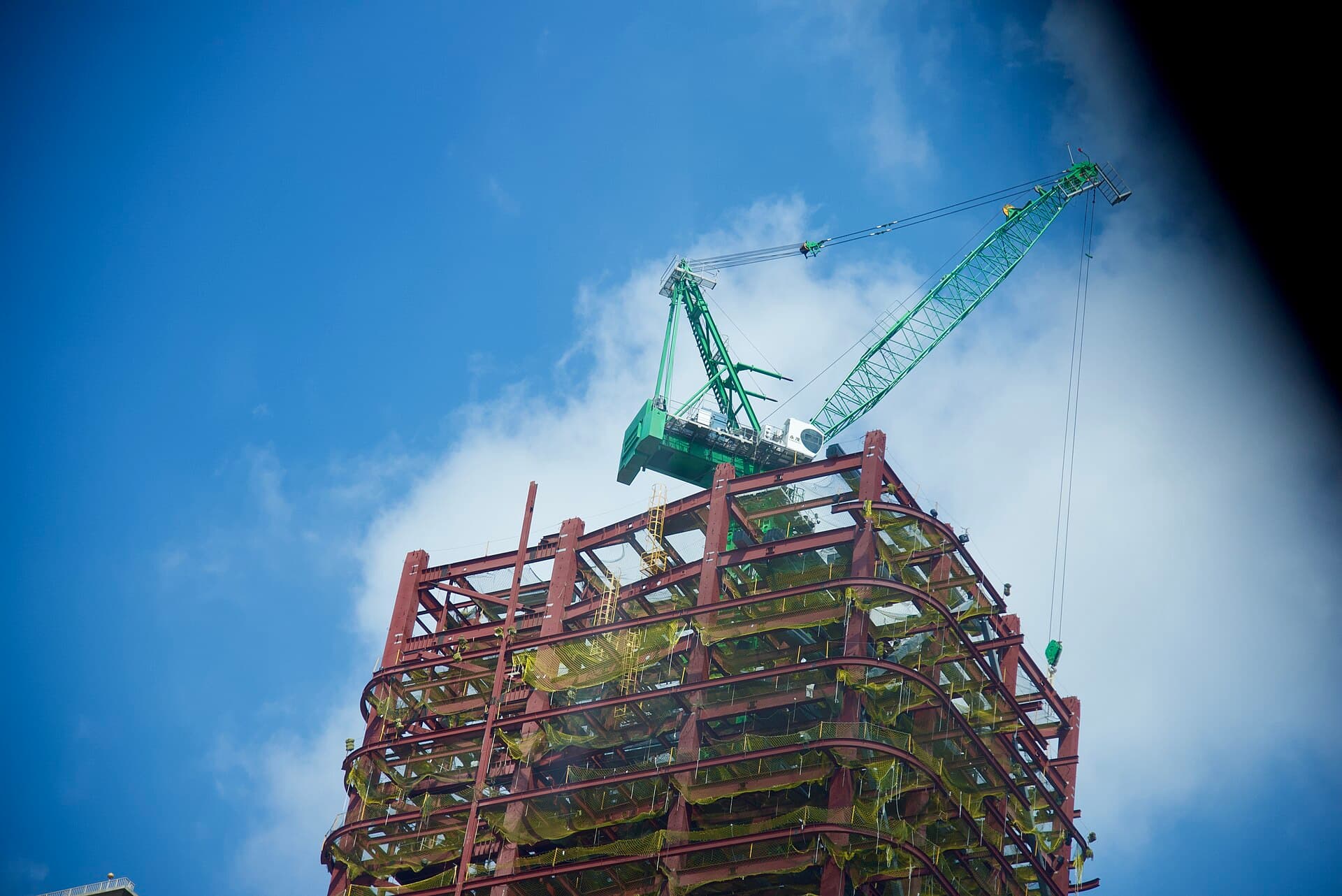 Steel frame of a building under construction against open sky