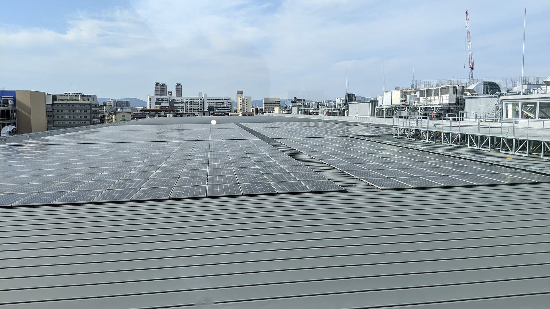 Rows of a utility-scale solar array on cleared ground