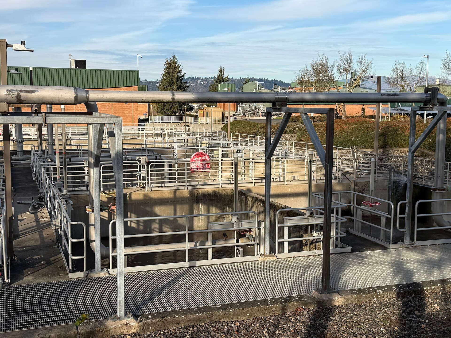 Secondary clarifier tanks and pipework at a wastewater treatment works